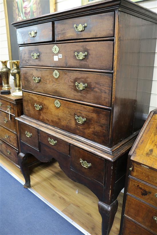 A Georgian oak chest on stand, W.106cm